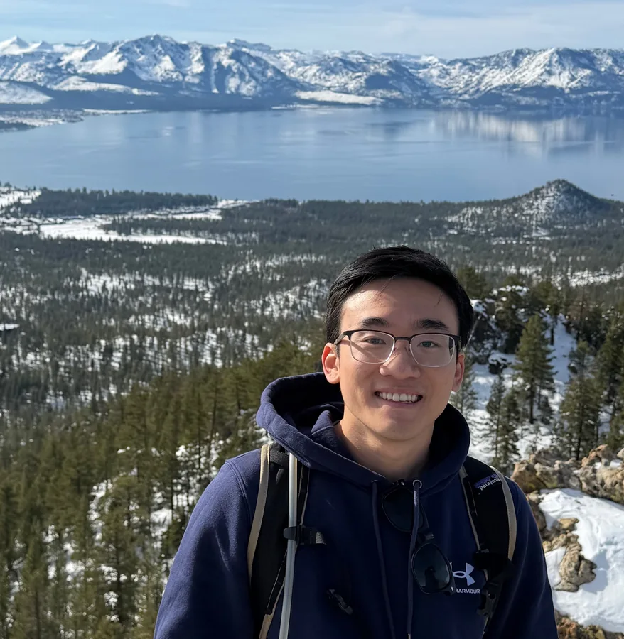 Michael Lam beside a snowy lake.