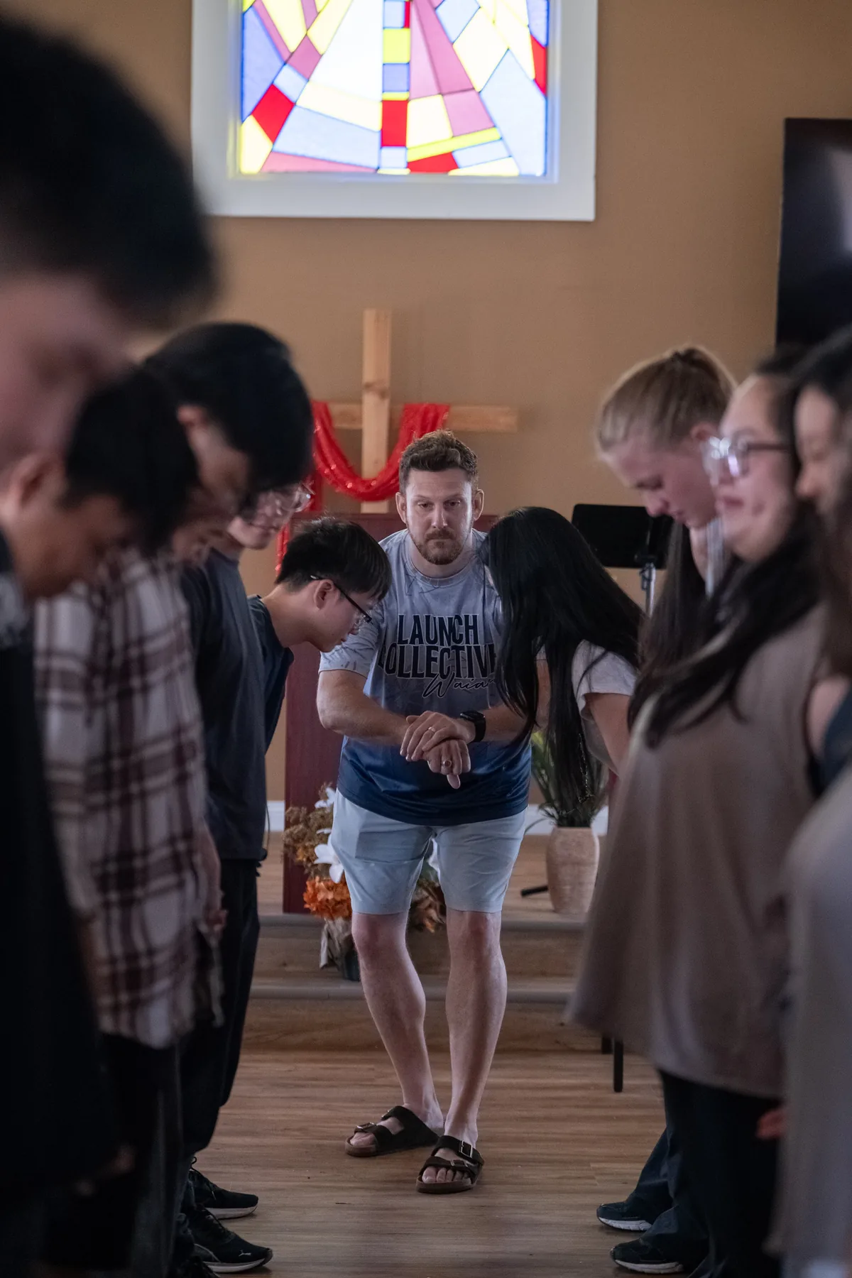 Students gathered in a team-building circle inside the church.