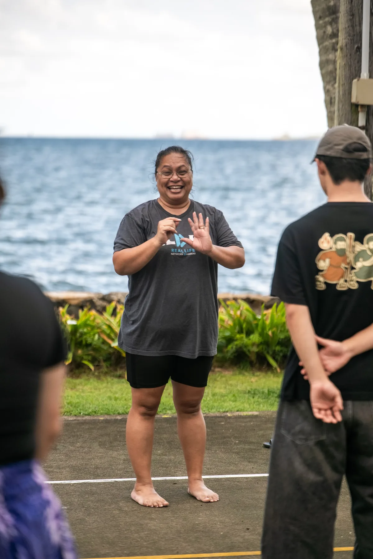 Hula instructor teaching the team near the water in Kāneʻohe.