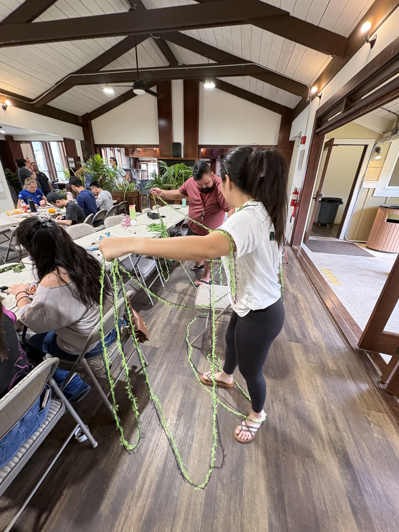 Team members making leis inside Kāneʻohe Congregational Church.