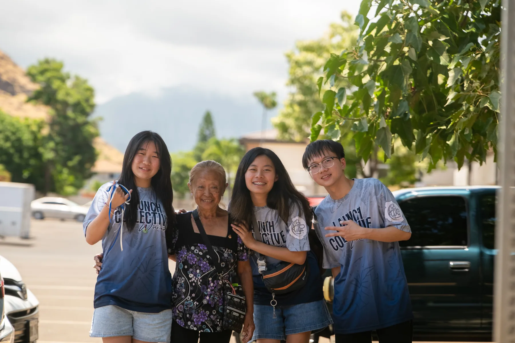 Team members standing outside with a local community member.