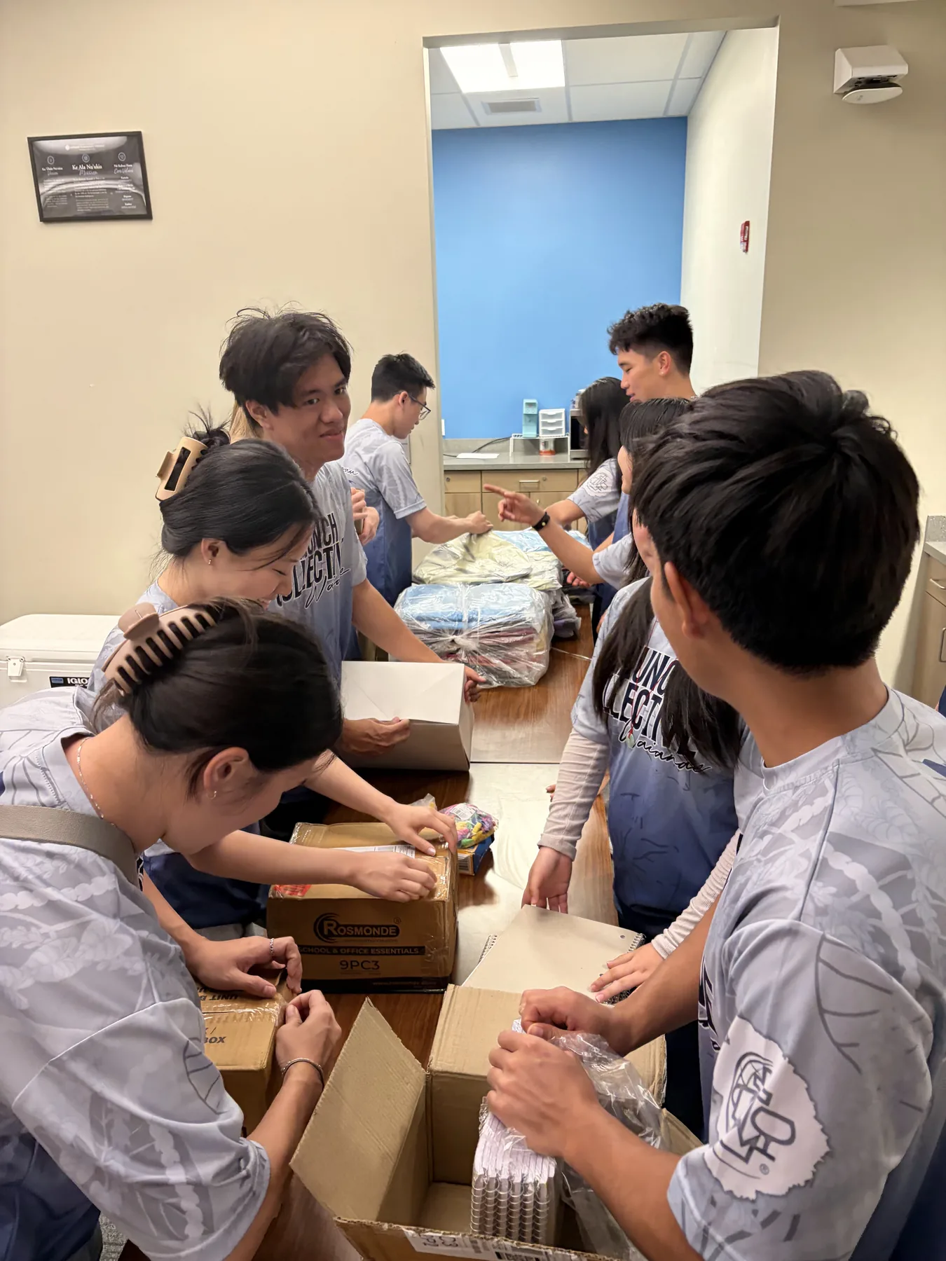 Team members assembling backpacks and supplies for children.