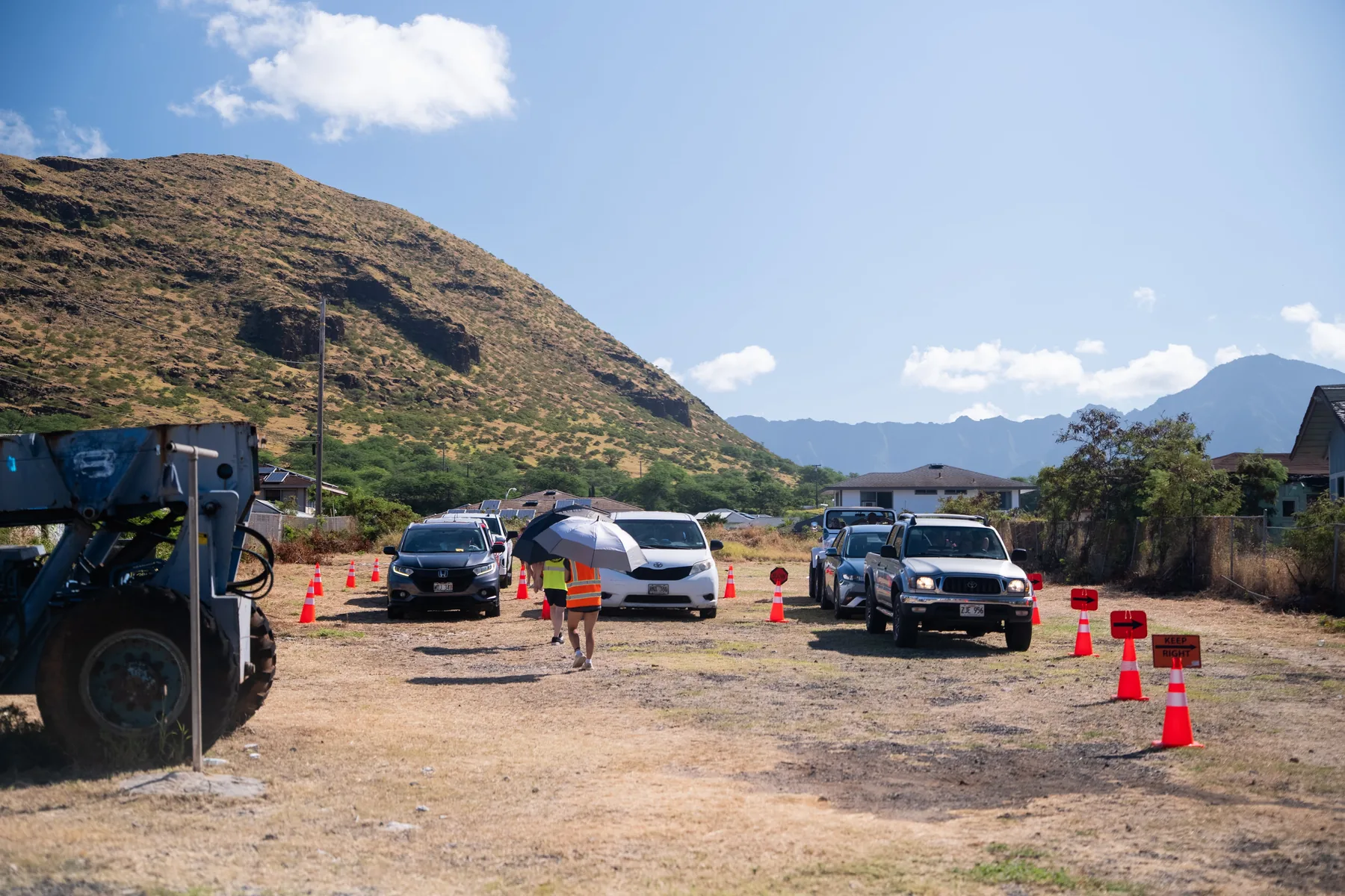 Cars driving through the food distribution line near the church.