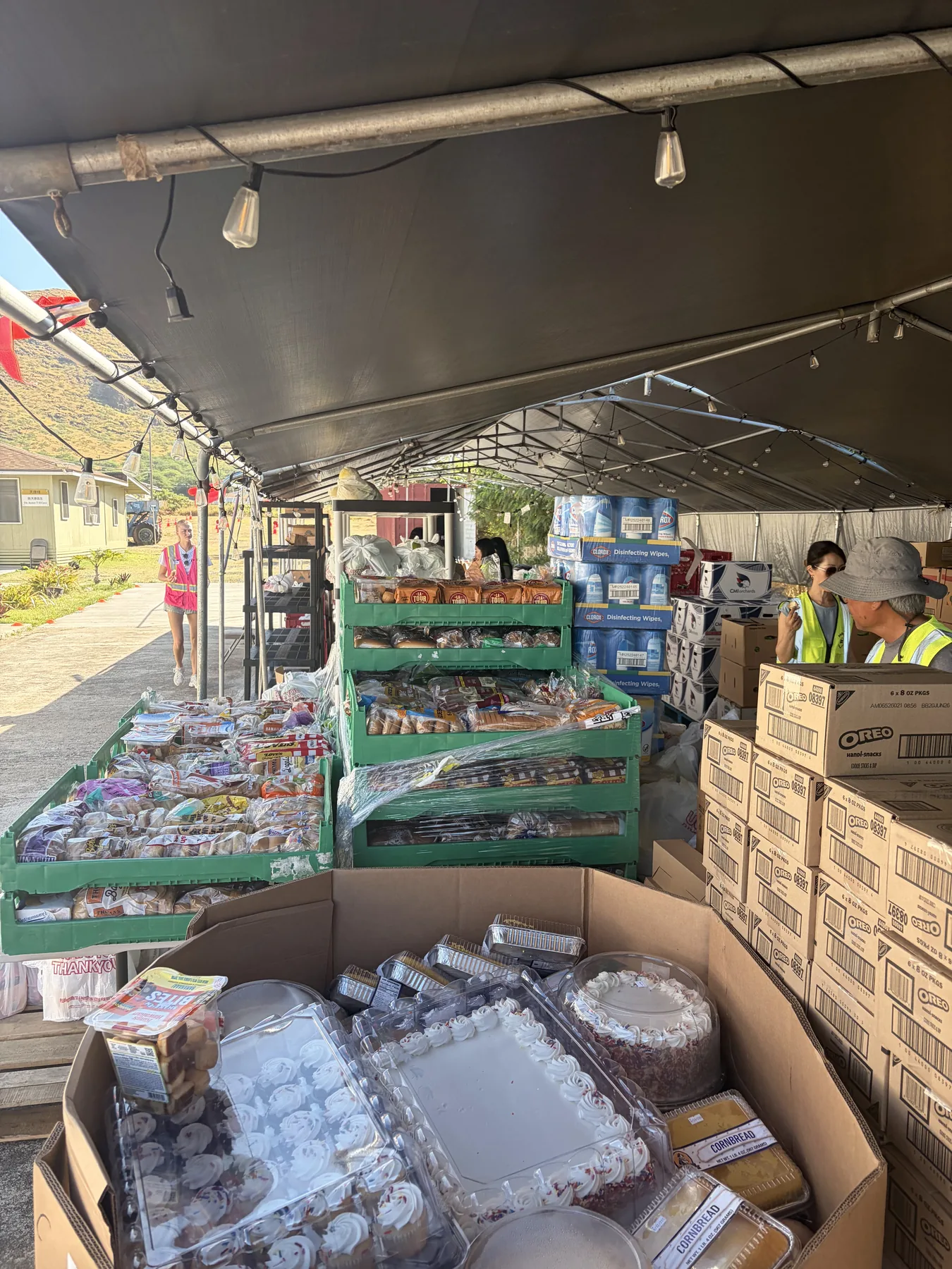 Tables and boxes filled with food prepared for distribution.