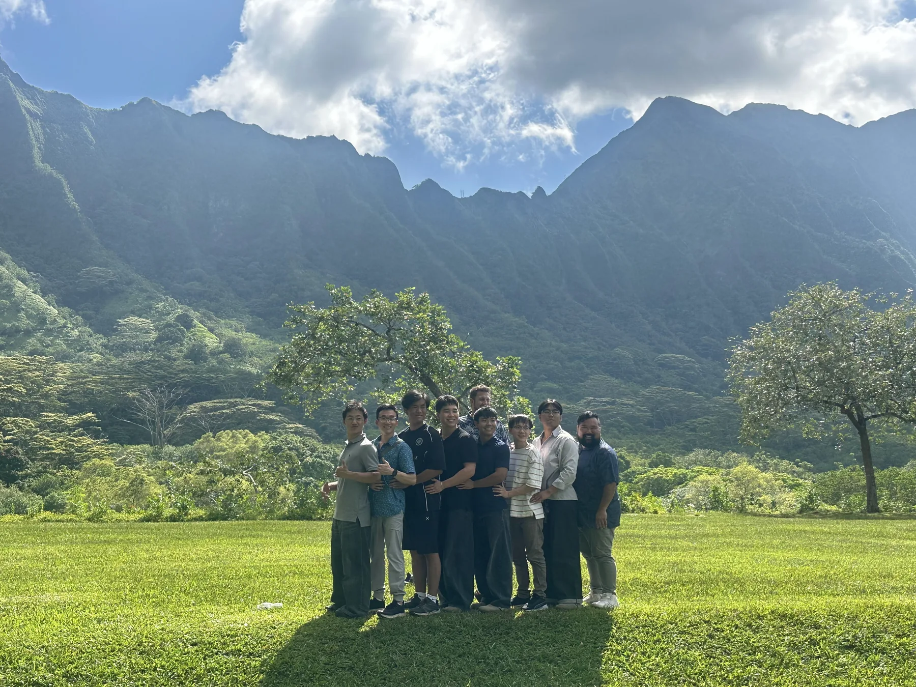 Small group standing in front of the mountain backdrop at the botanical garden.