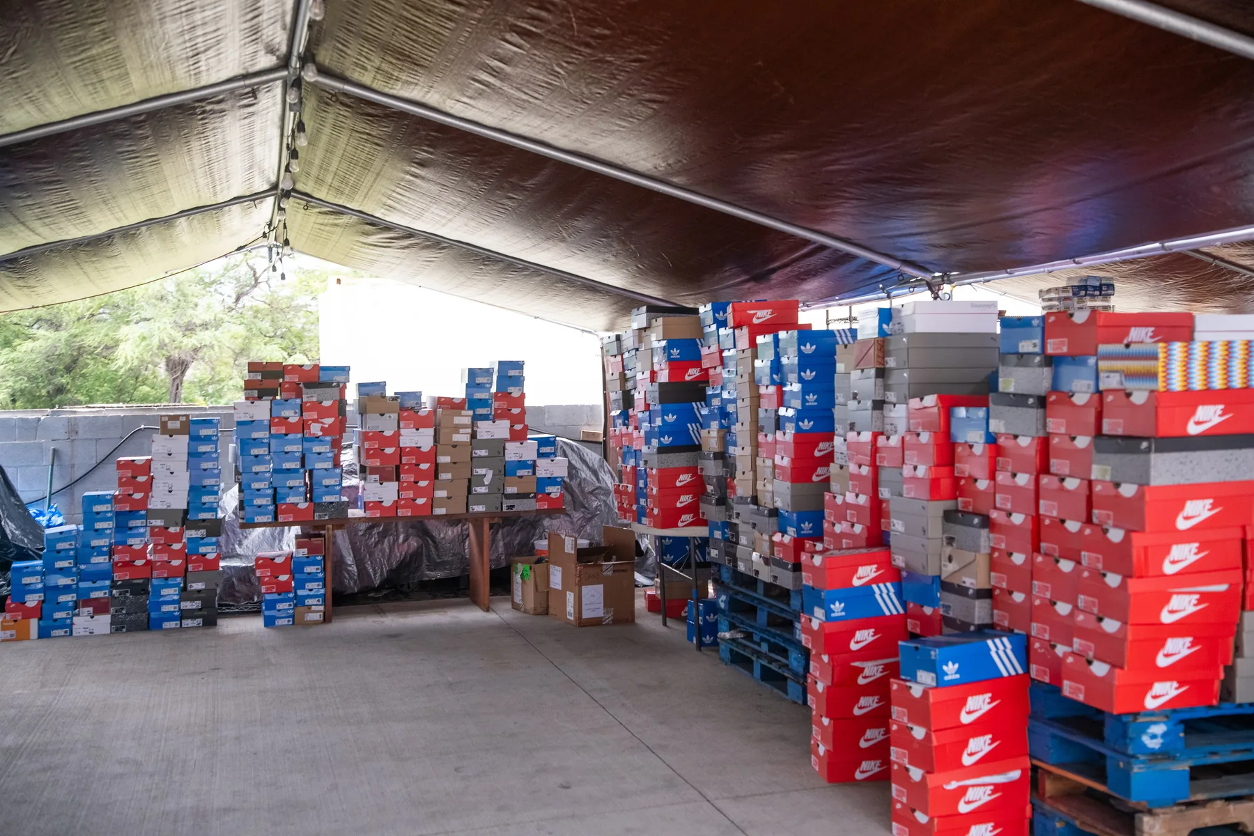 Stacks of sorted shoe boxes lined up under the church awning.