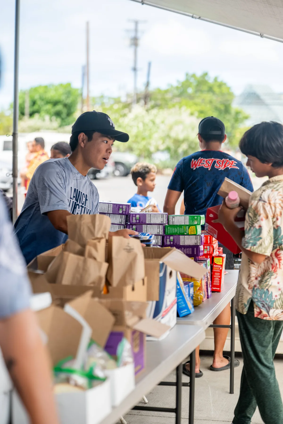 Volunteers preparing and handing out meals and snacks at the shoe drive.