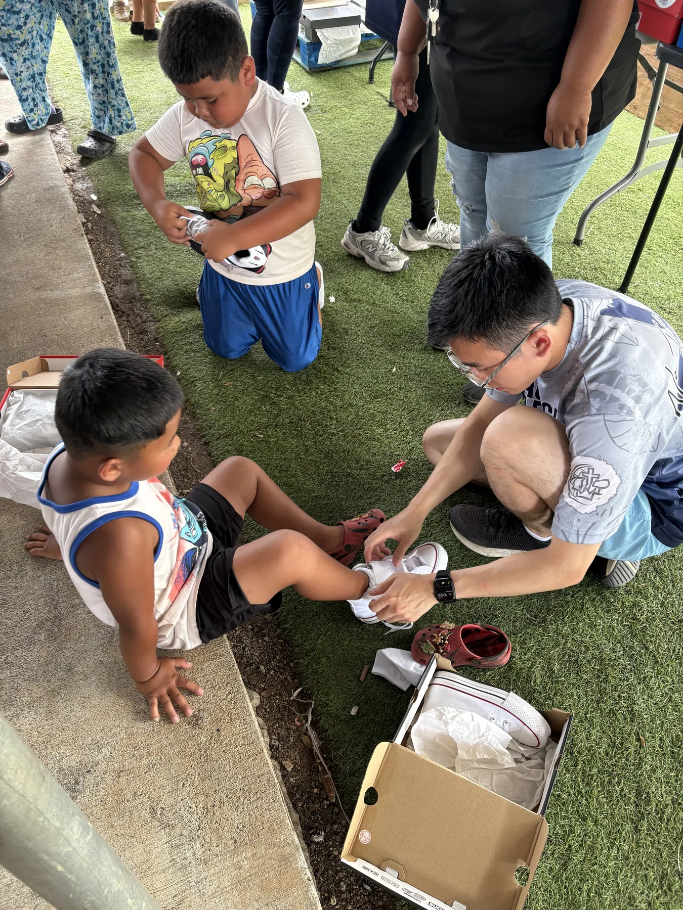 A child trying on shoes during the shoe drive.