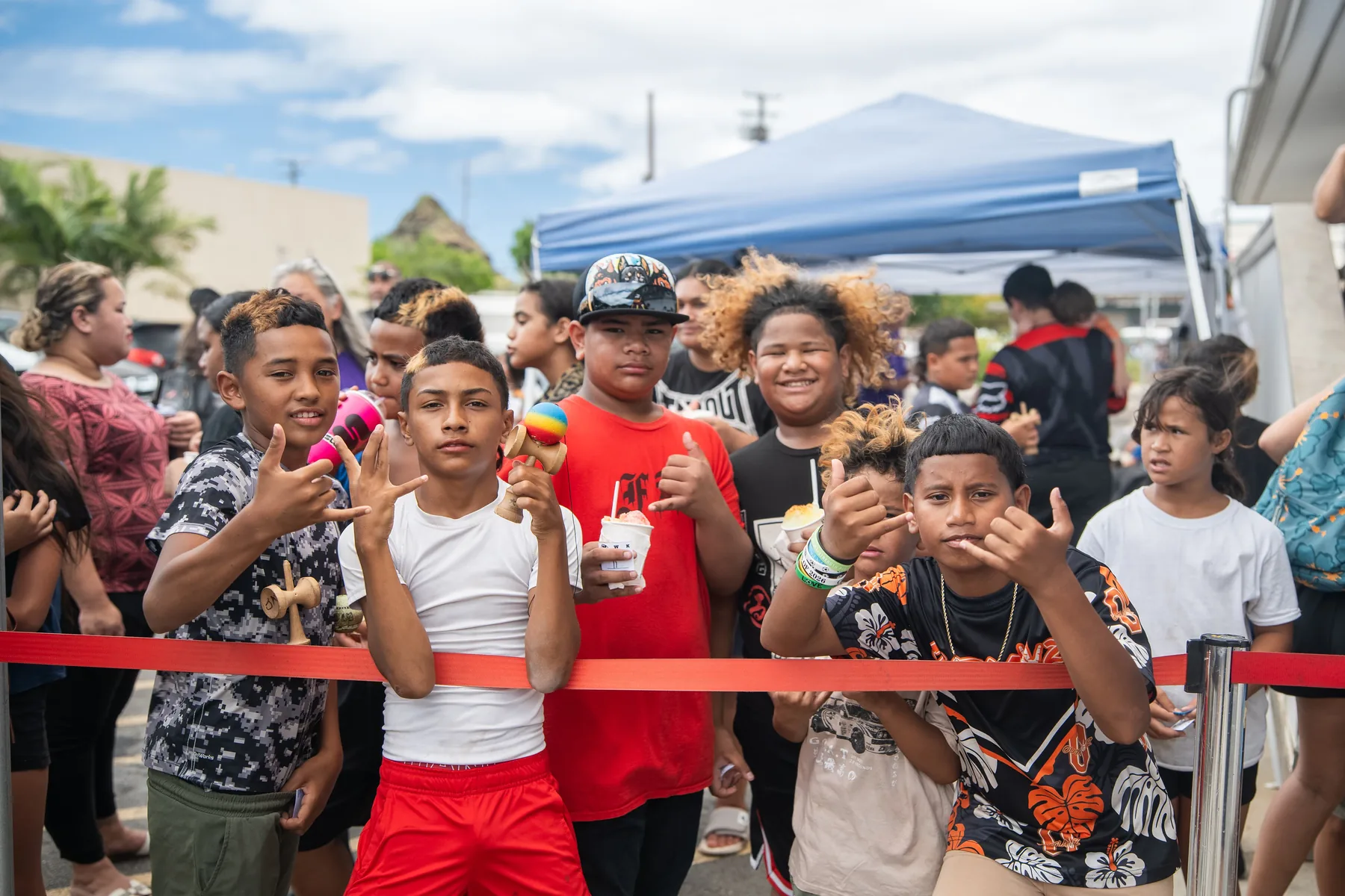Local kids smiling together while waiting at the shoe drive.